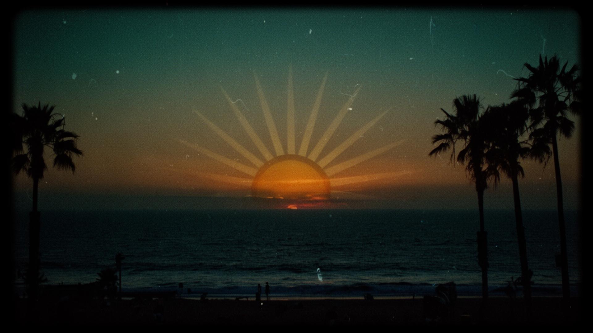 Sublime sun setting over the Long Beach ocean with palm trees
